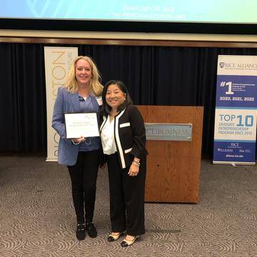 Two women holding award
